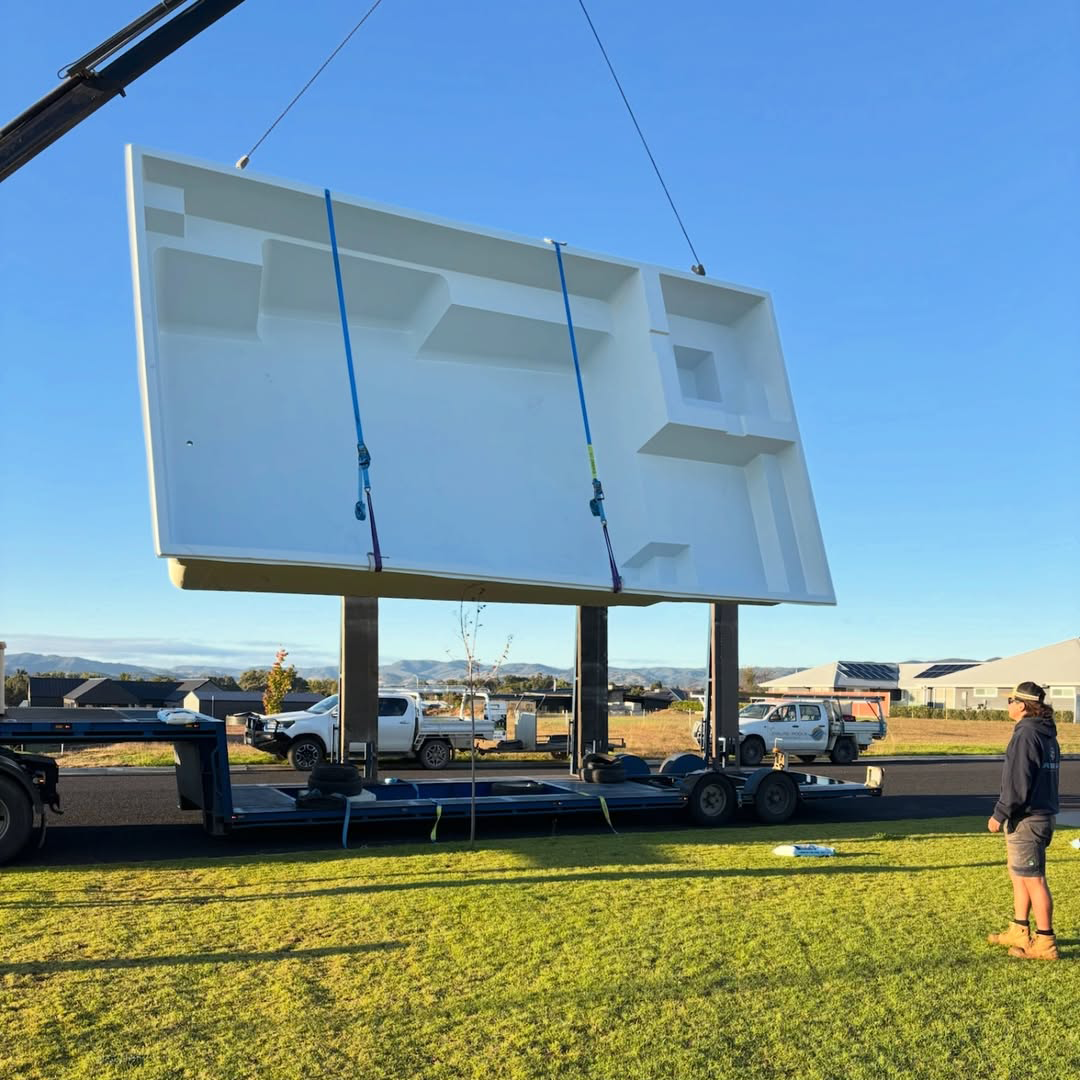 Fibreglass swimming pool shell being craned into position