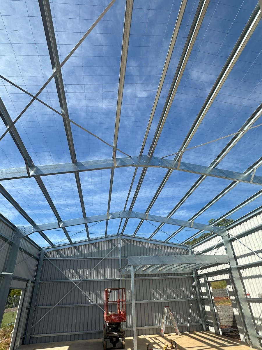 Bolted steel shed portal frames during construction